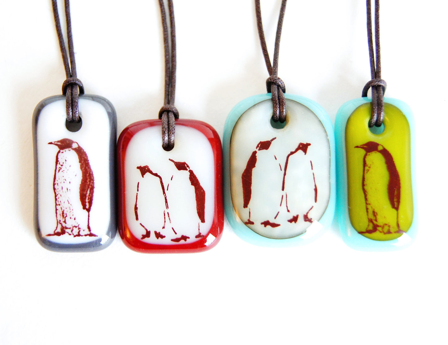 A limited batch of four Emperor Penguin glass pendant necklaces