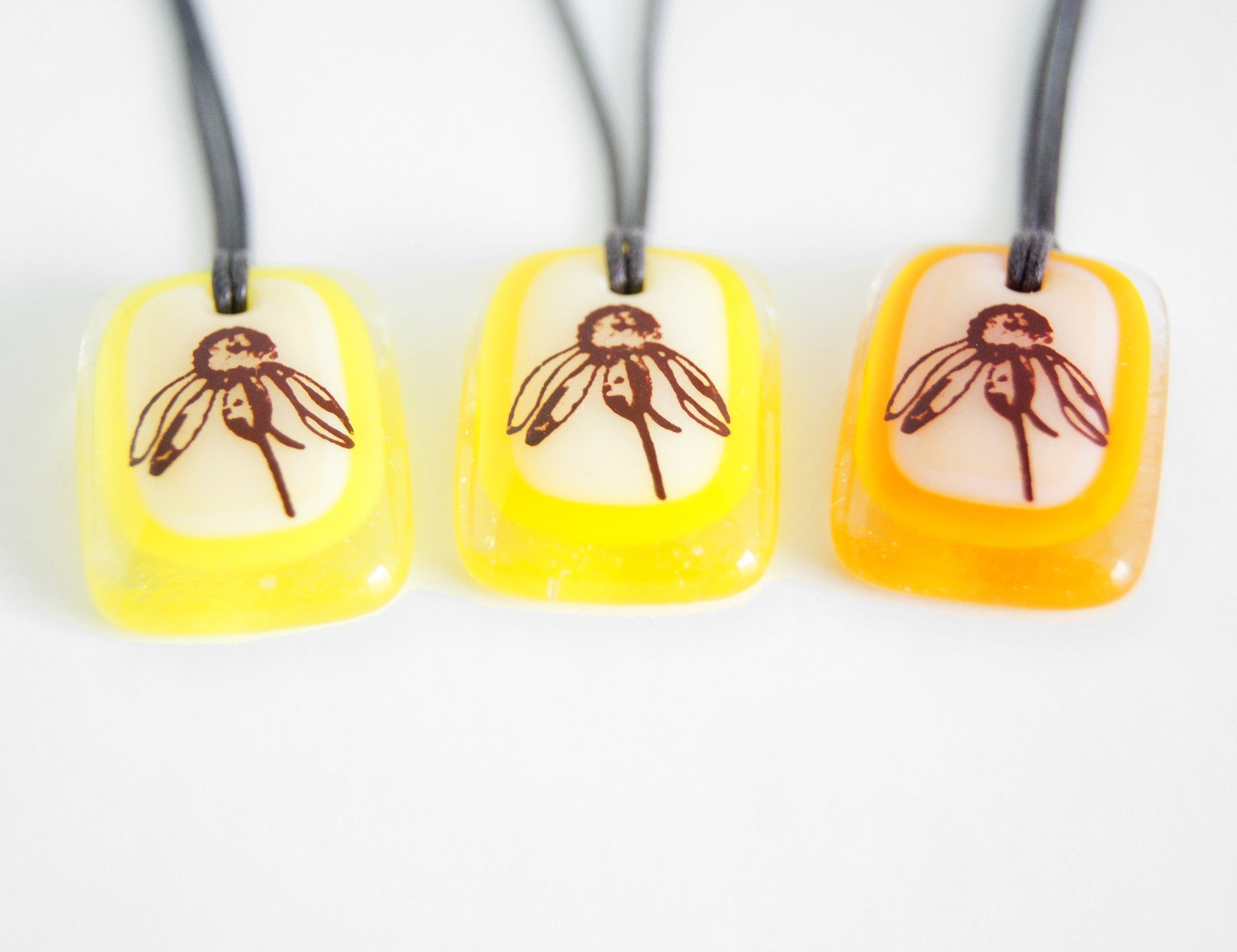 Wild Flower pendant necklace in marigold orange.