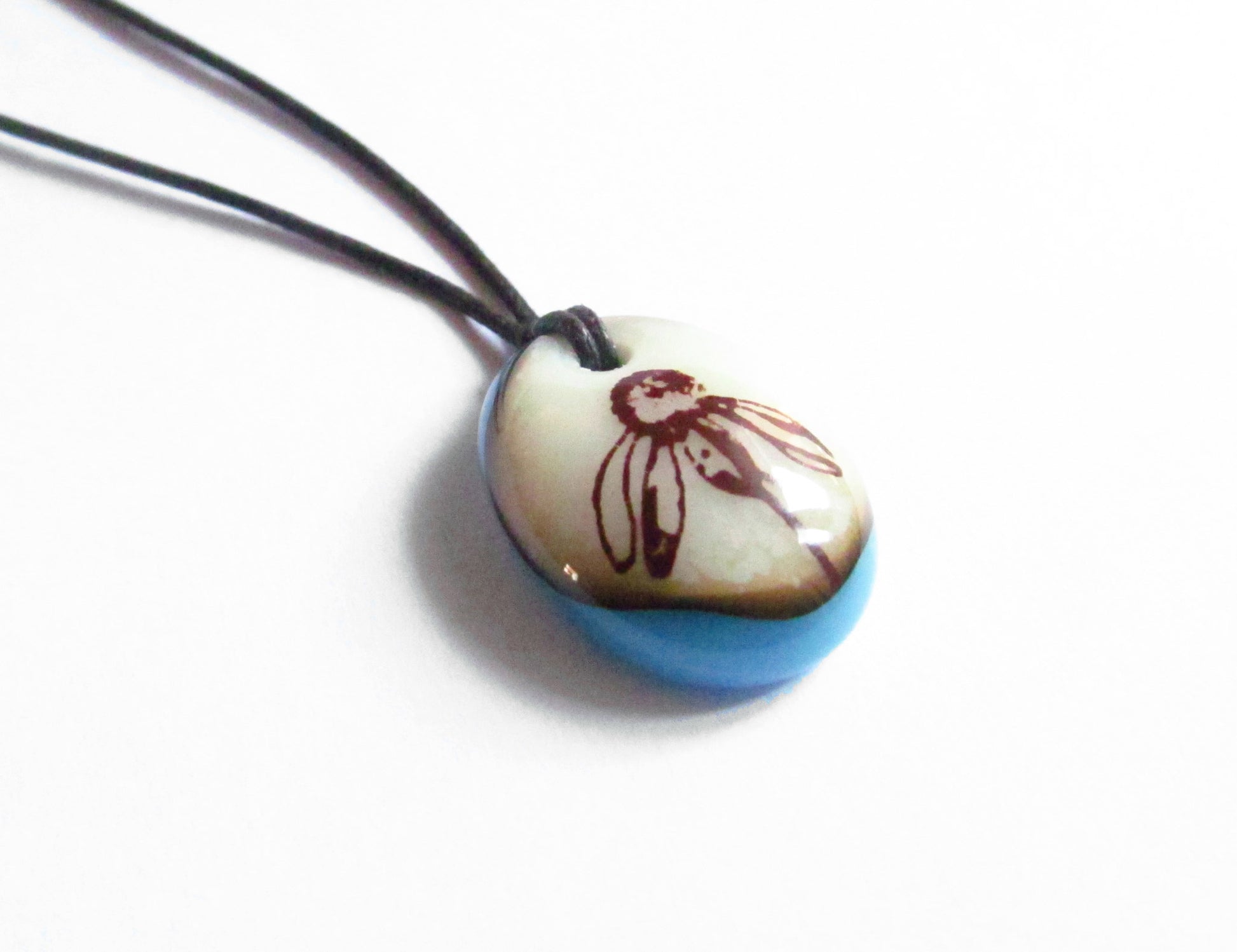 Botanical pendant on cotton cord necklace. 