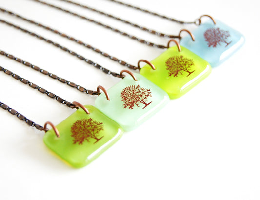 Blue kiln-fired glass pendant handcrafted with large orchard tree illustration