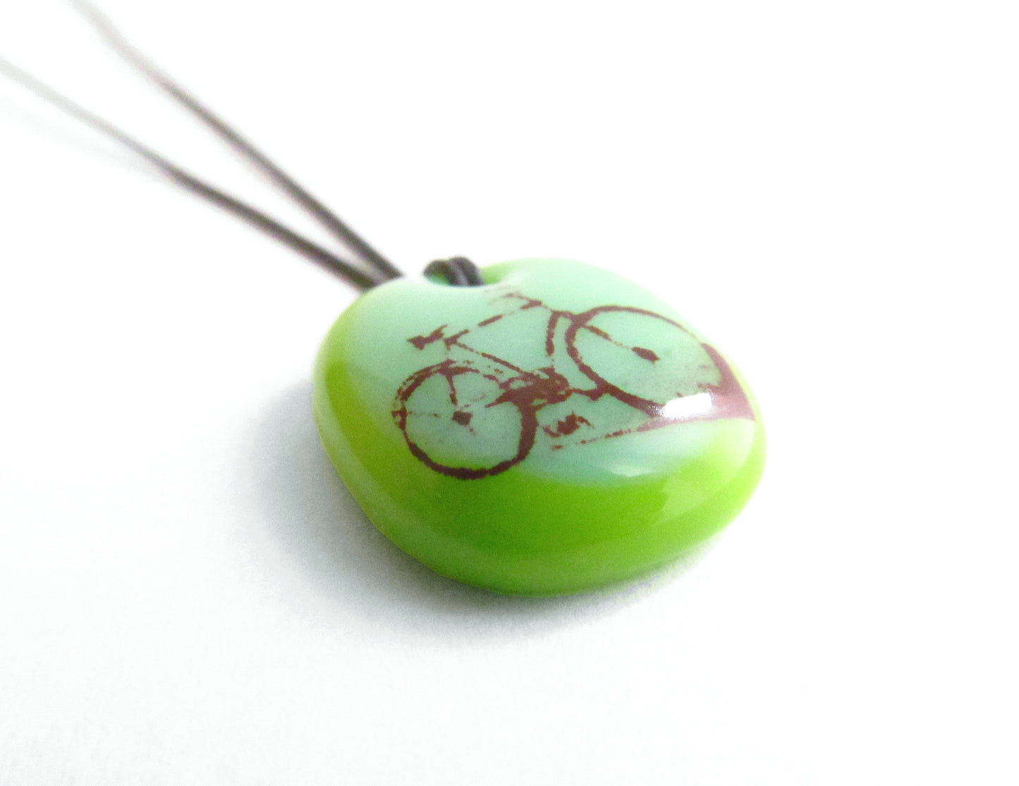 Green bicycle necklace handmade by Leila Cools.