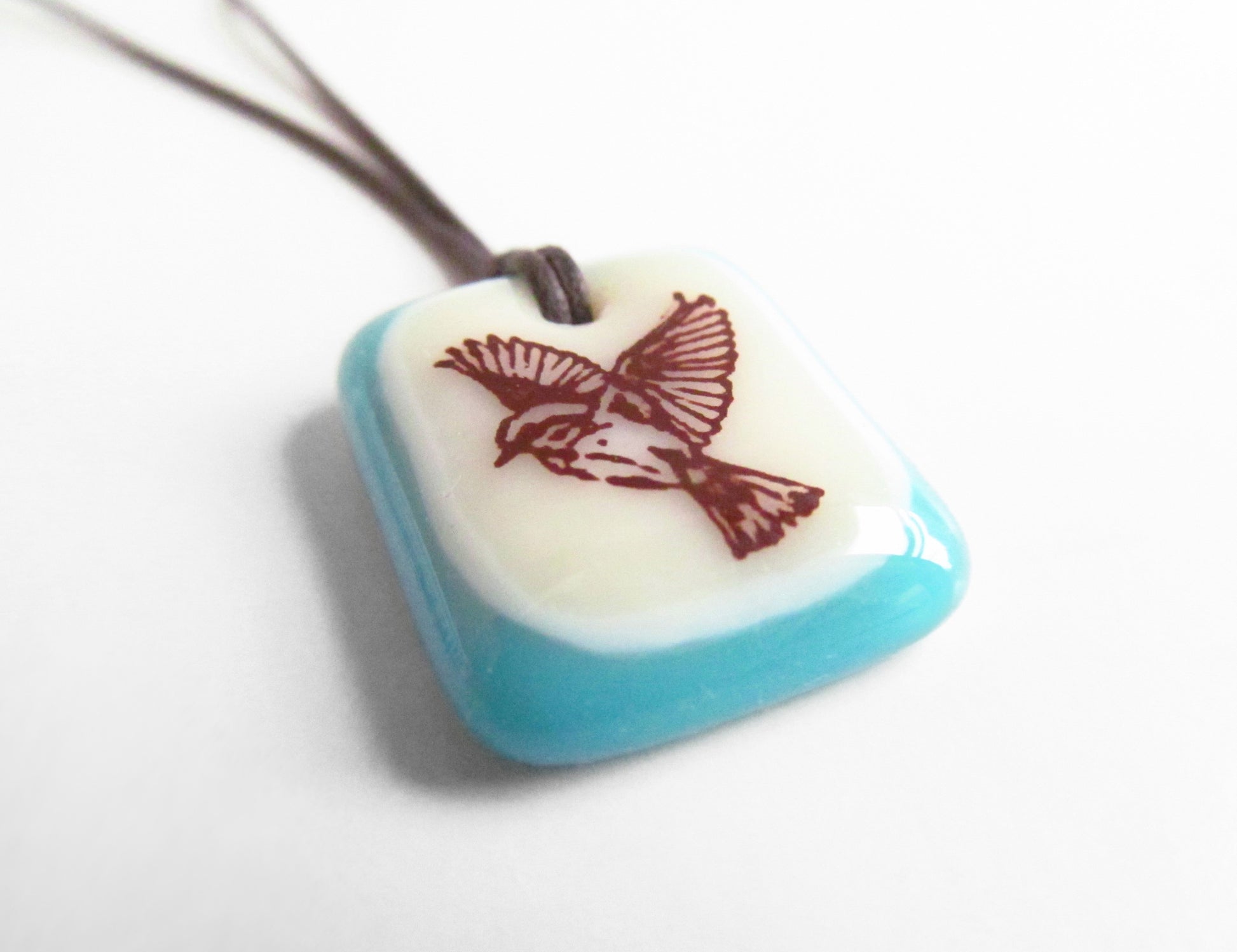 Freedom bird image on a handmade glass pendant necklace.
