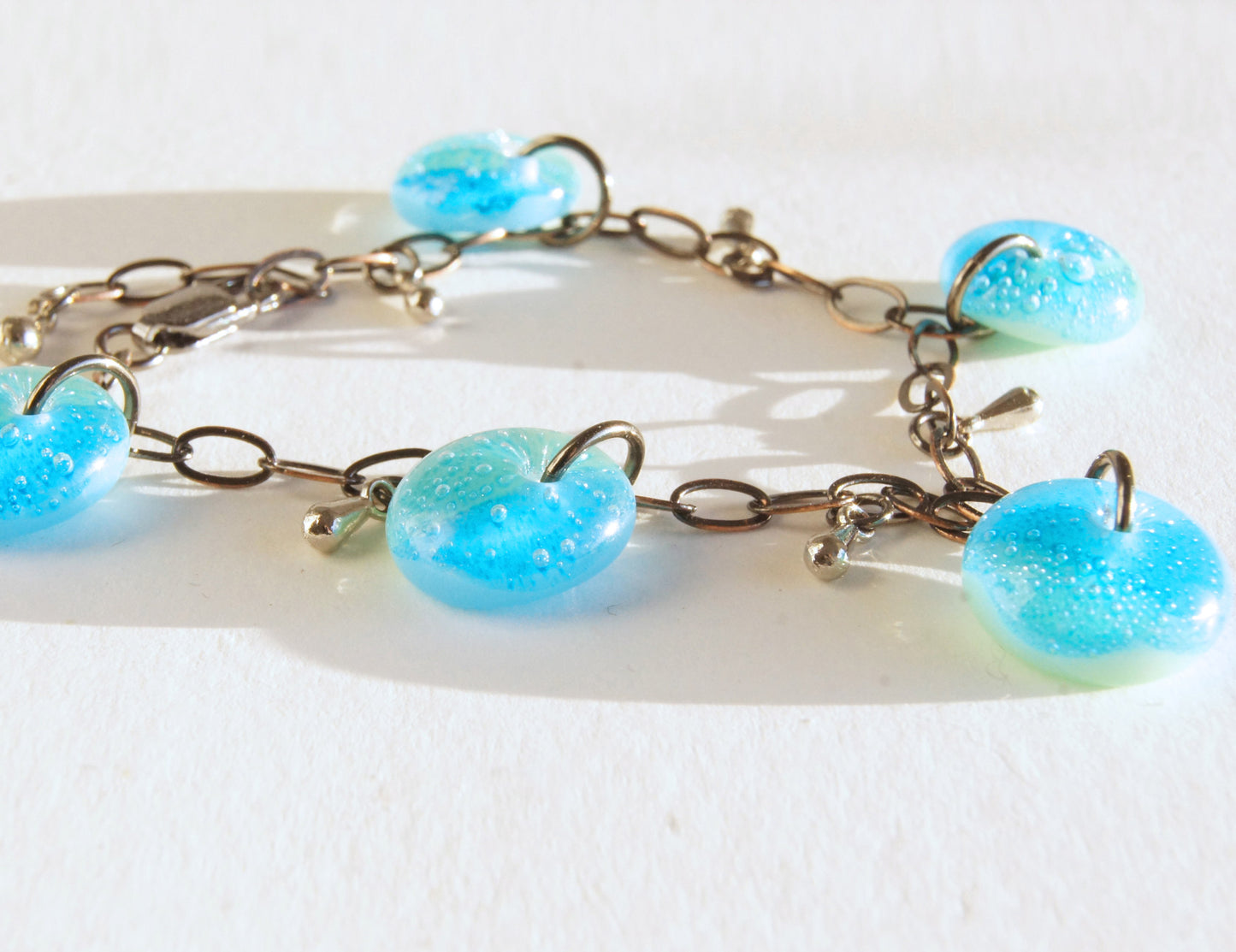 Ooak charm bracelet with fused glass patina blue drops, stainless steel tear drop beads and bronze chain