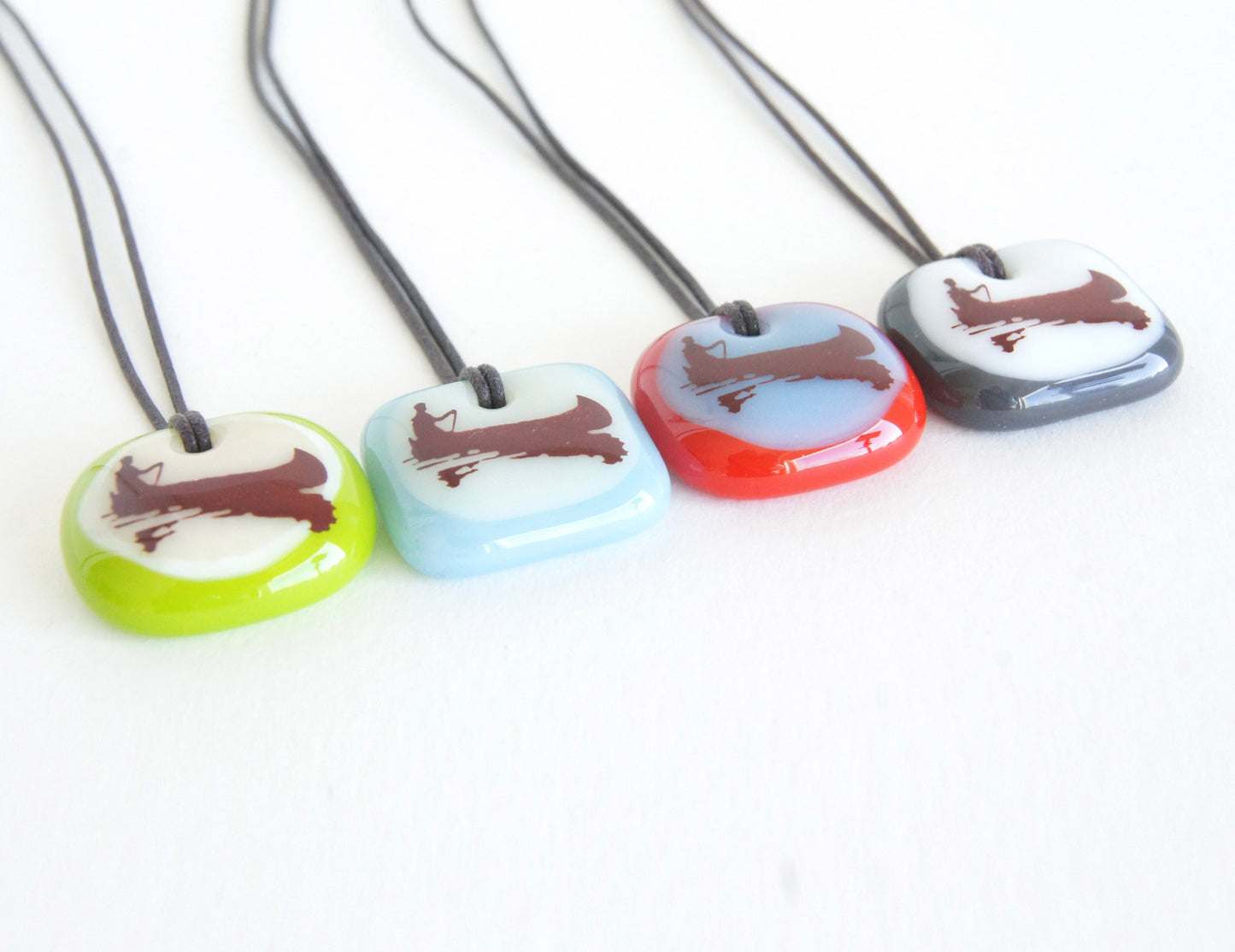 Your choice of handmade canoe necklace on cotton cord.