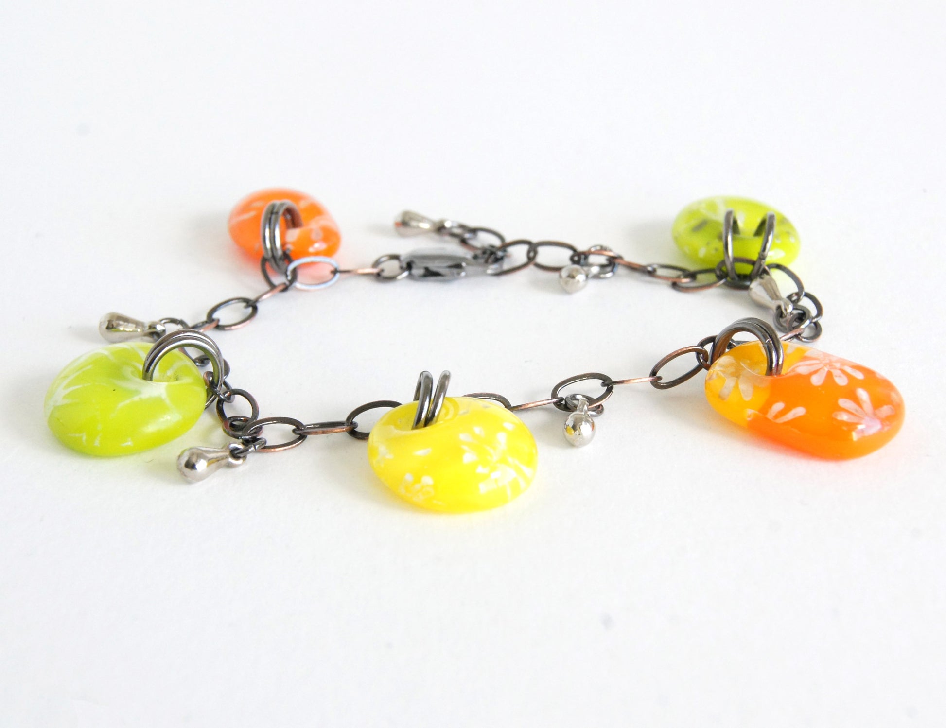 Summery yellow, green and orange glass drop bracelet on bronze color chain.