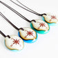Your choice of handmade compass necklace on cotton cord. 
