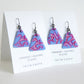 delicate glass triangle earrings with vine design