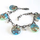 Green and aqua blue filigree design glass drop charm bracelet with dark copper chain.