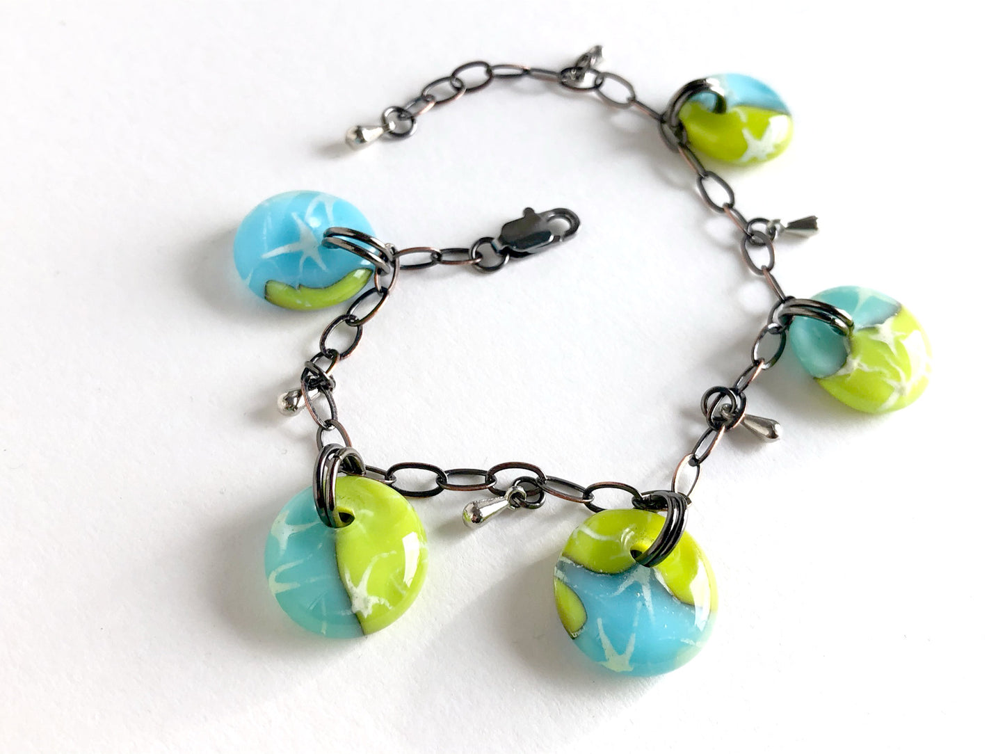 Handmade glass drop bracelet in blues and greens with bronze chain and small steel glass drop beads.