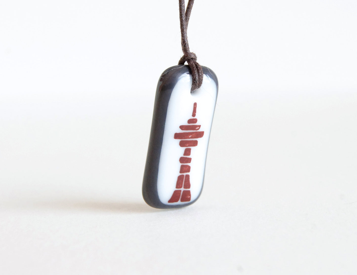 Inukshuk necklace with Toronto CN Tower.