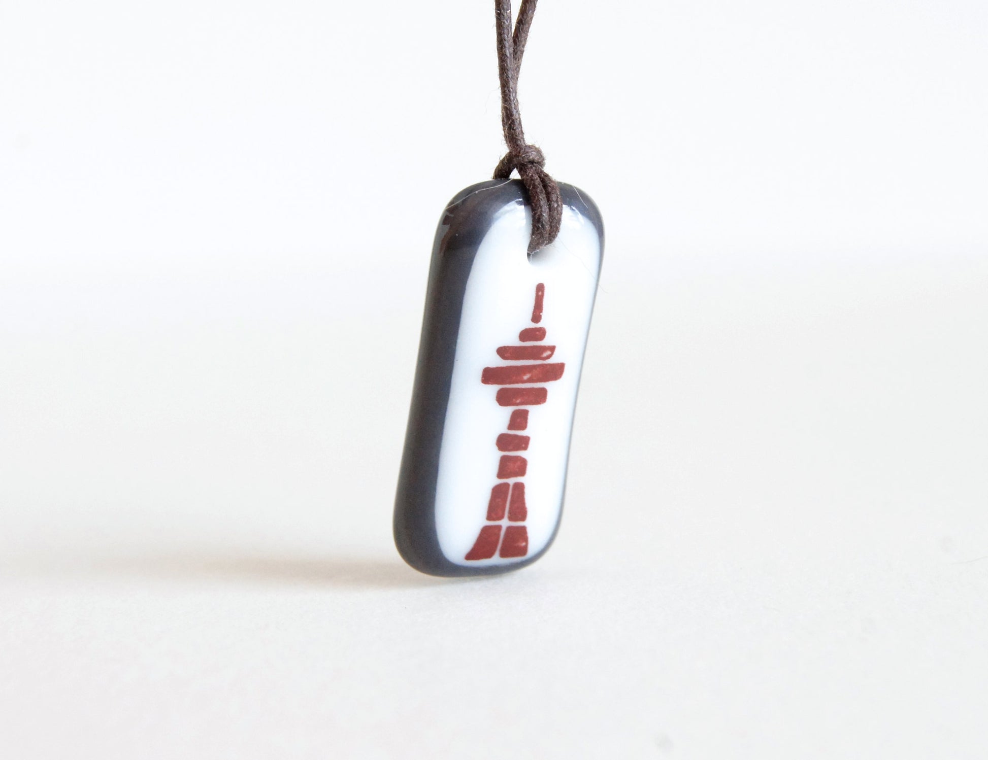 Inukshuk necklace with Toronto CN Tower.