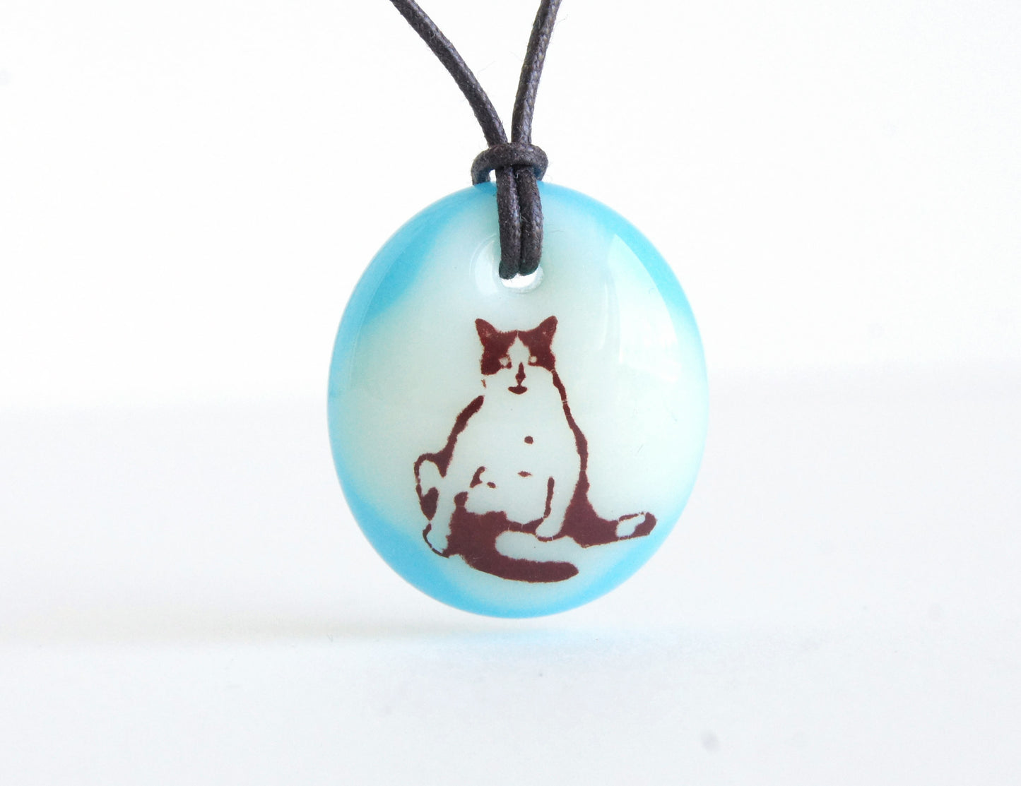 Funny cat pendant in cream and aquamarine.