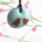 Love birds necklace in pastel green and blue colors. 