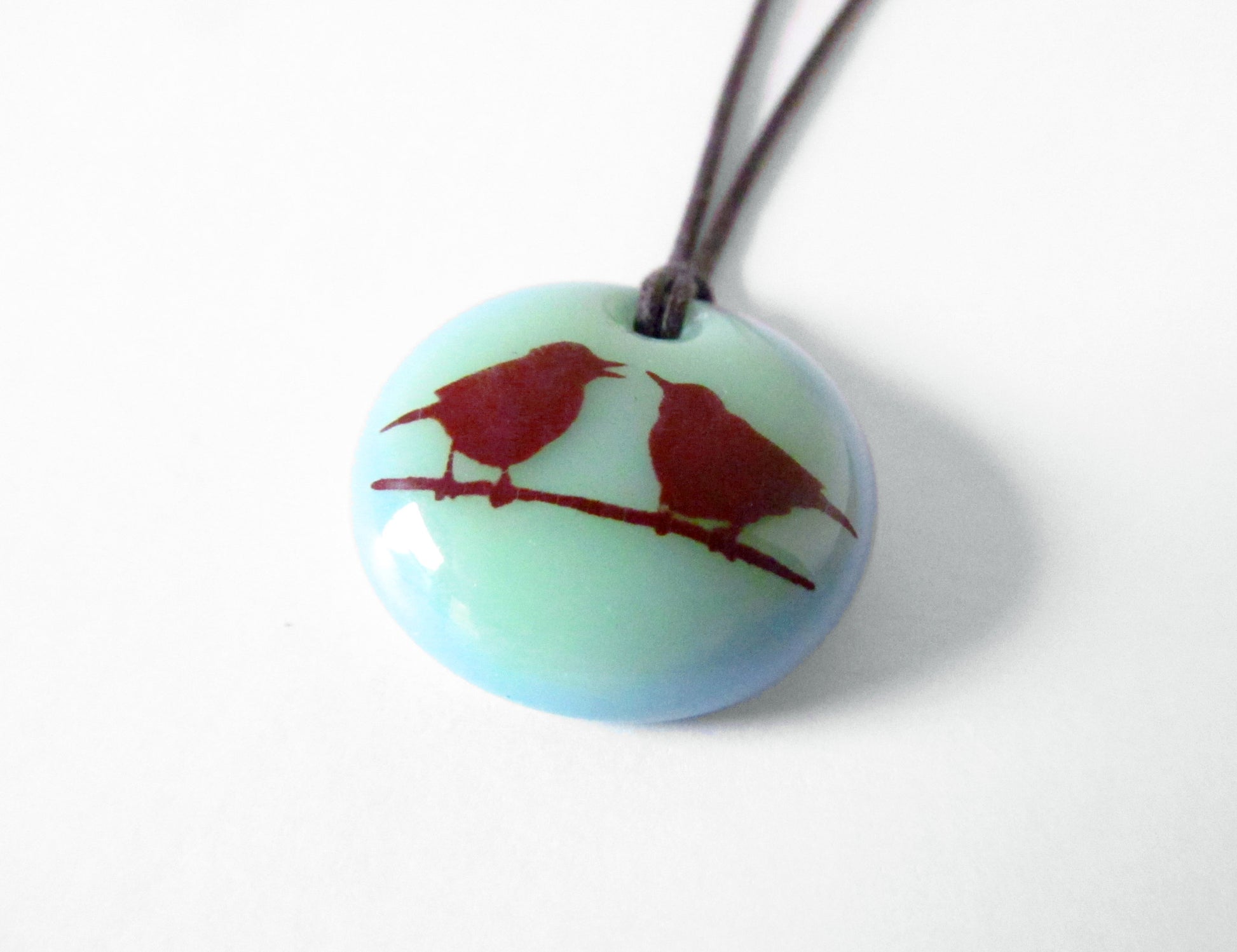 Love birds pendant on cord necklace.