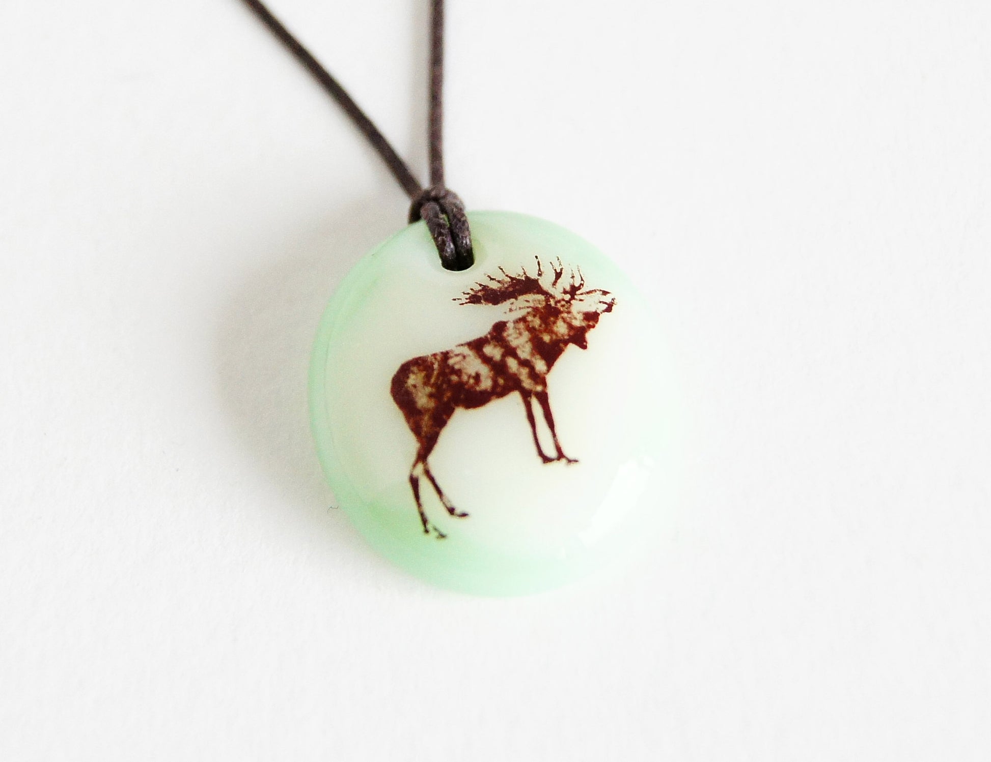 Moose necklace handmade in light green glass. 