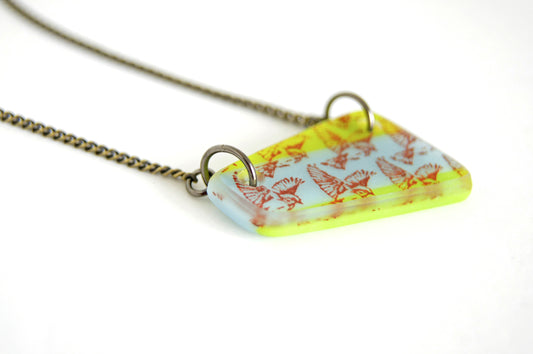 Flying Bird Necklace in olive green and light blue.