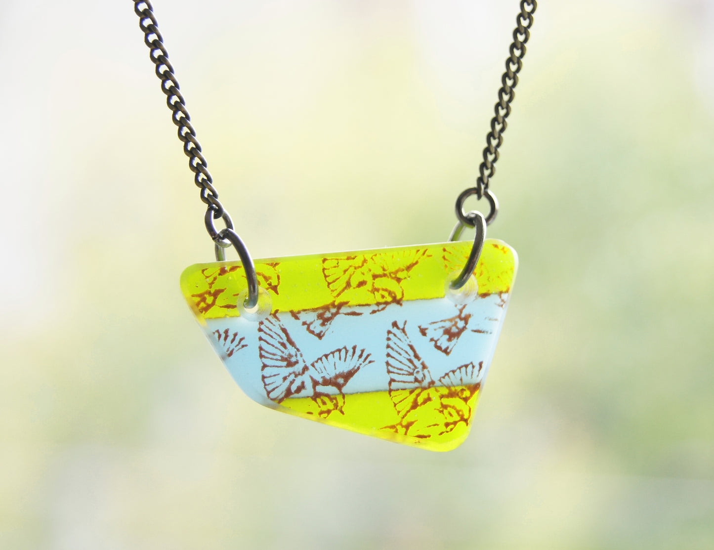 Handmade bird jewellery in green and turquoise.
