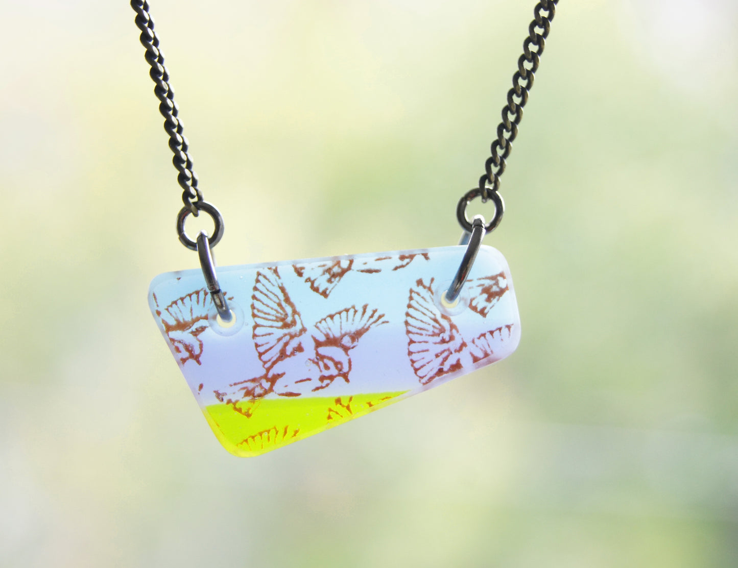 Triangular glass bird pendant handmade in glass.