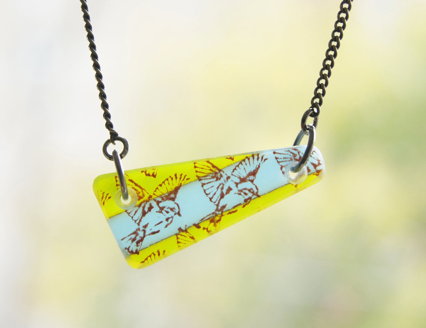 Rustic colours bird pendant on brass chain.