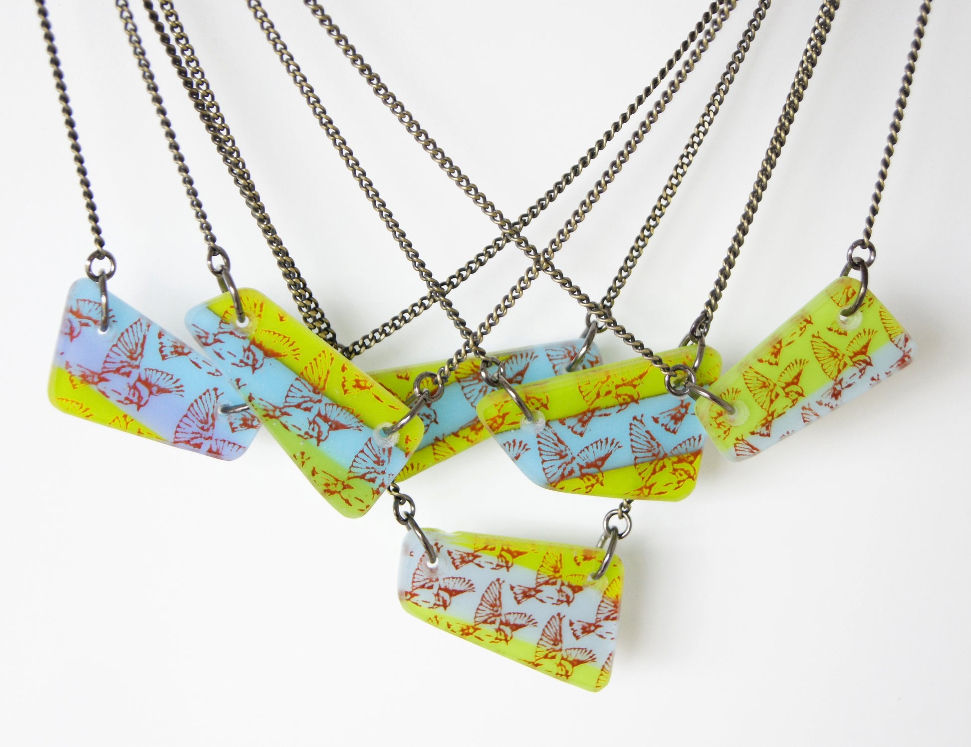 Handmade collection of one of a kind flying bird necklaces.