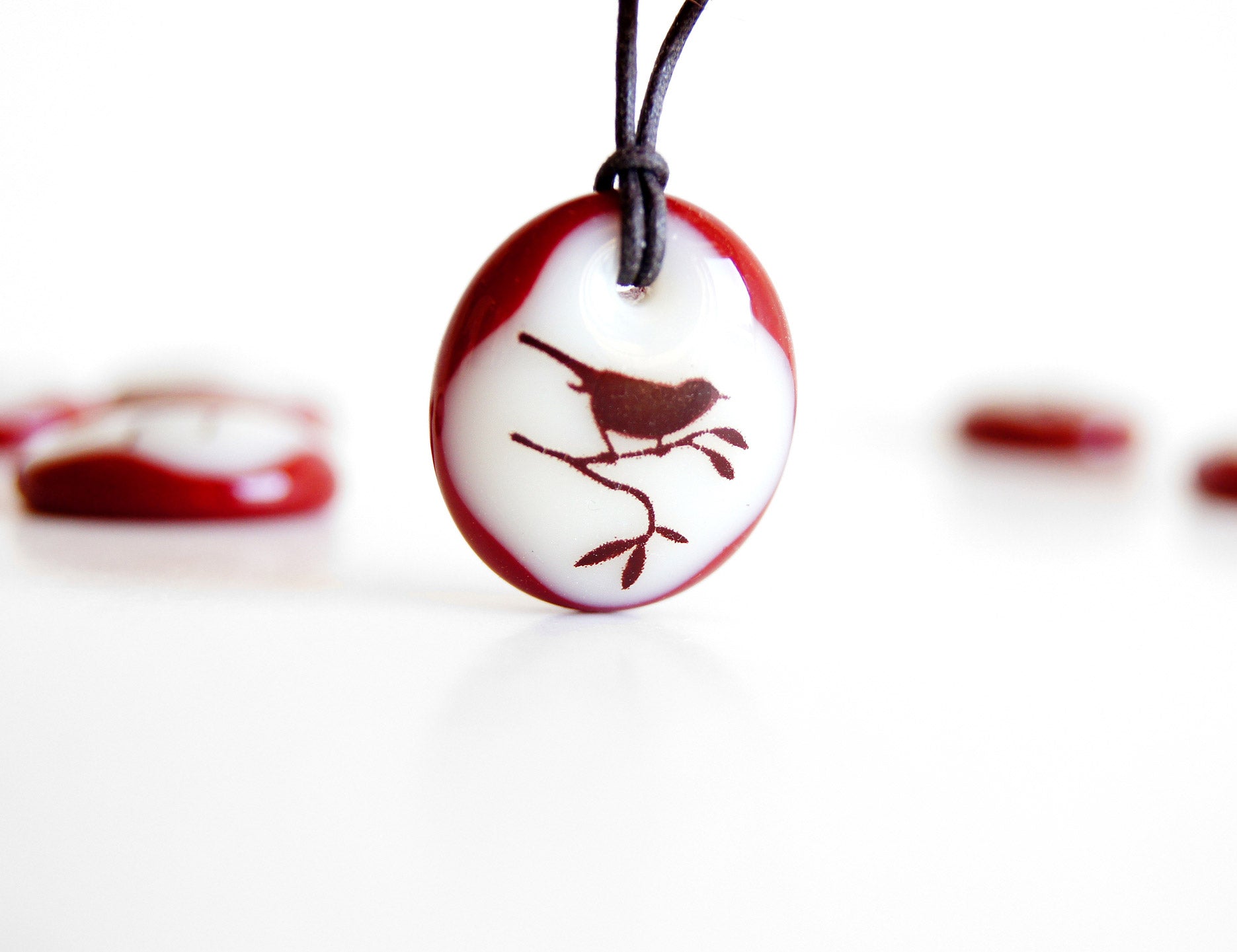 Red Bird Necklace in cream and dark red colours.