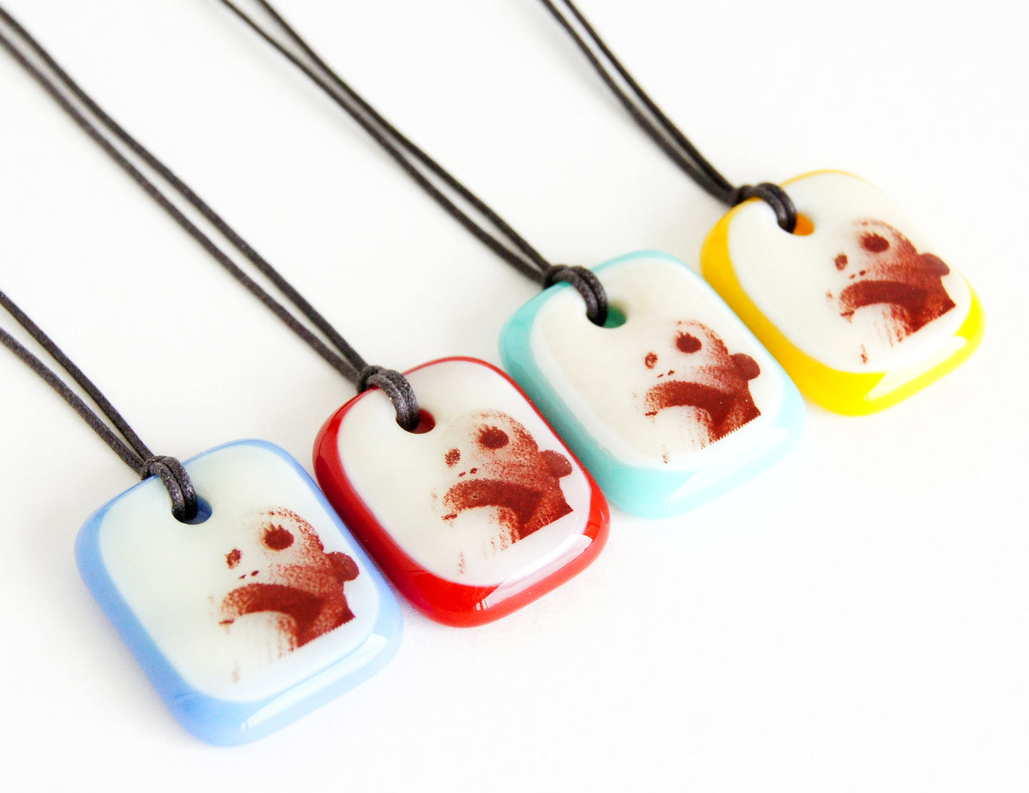 Your choice of handmade sock monkey necklace on cotton cord.