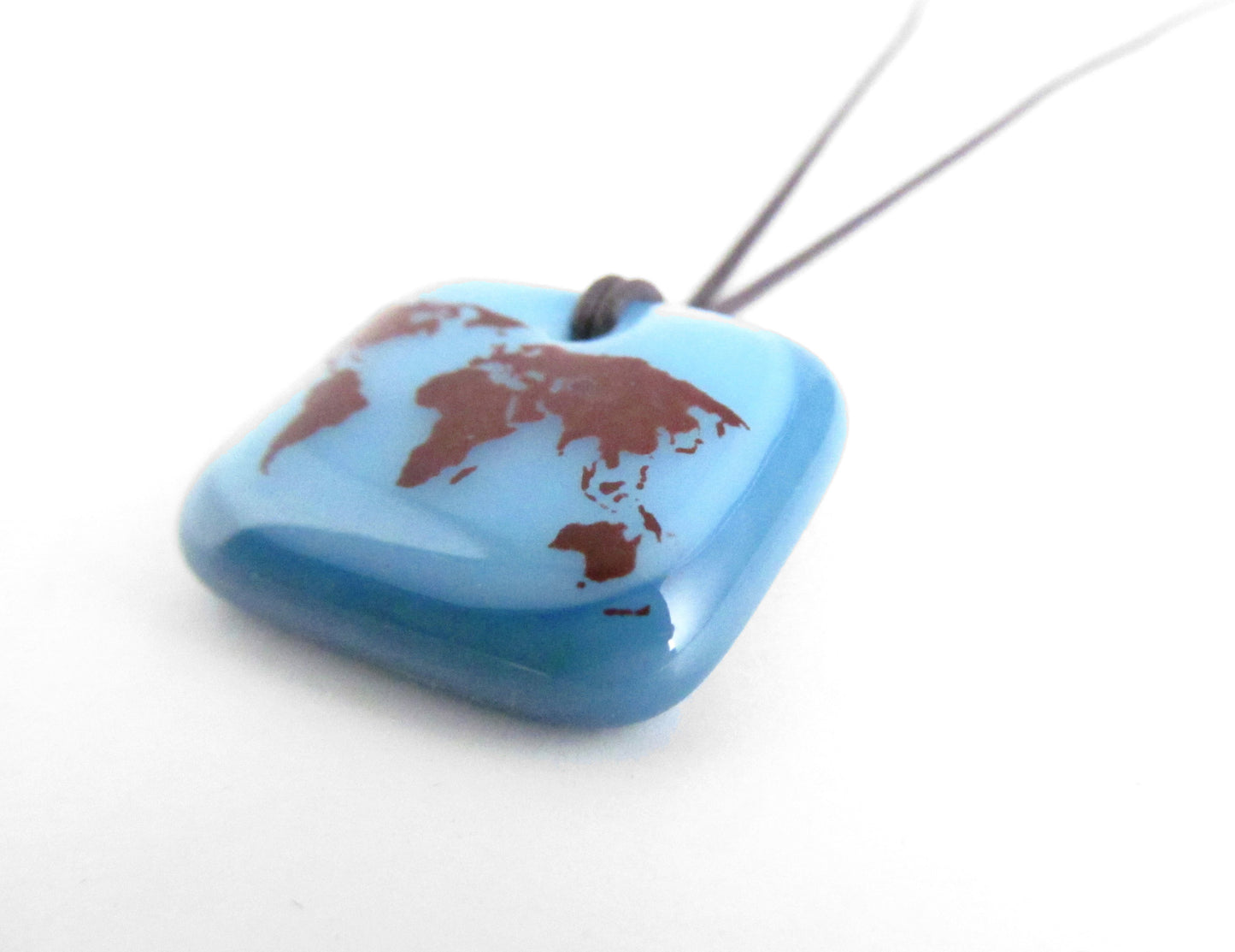 World map pendant necklace in pastel and dusty blue.