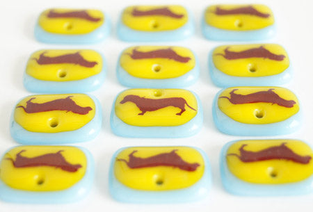 Dachshund pendant necklaces in yellow and blue handmade by Leila Cools