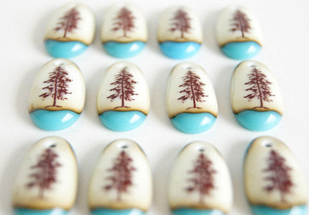 Twelve new pine tree pendants handmade in glass by Leila Cools