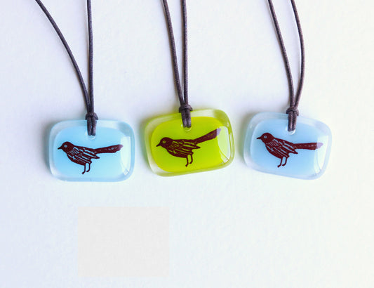 blackbird necklace three color options light aqua, green, and periwinkle blue