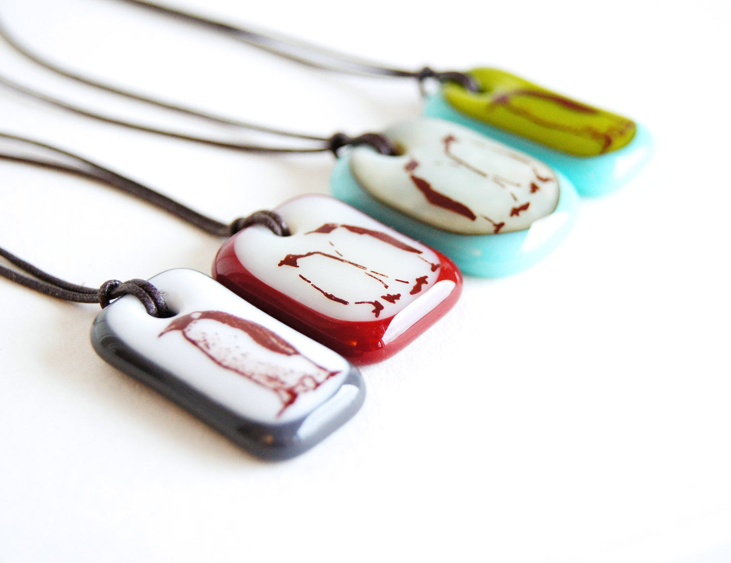 Fun penguin necklaces handmade in colorful glass