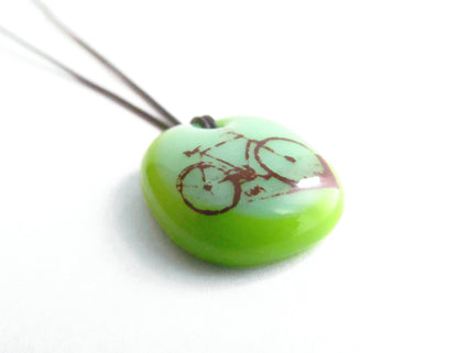 Green bicycle necklace handmade by Leila Cools. 