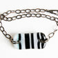 Fused glass bracelet with black stripes on white handmade by Leila Cools.