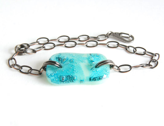 Turquoise and green organic design glass bracelet with adjustable bronze chain.