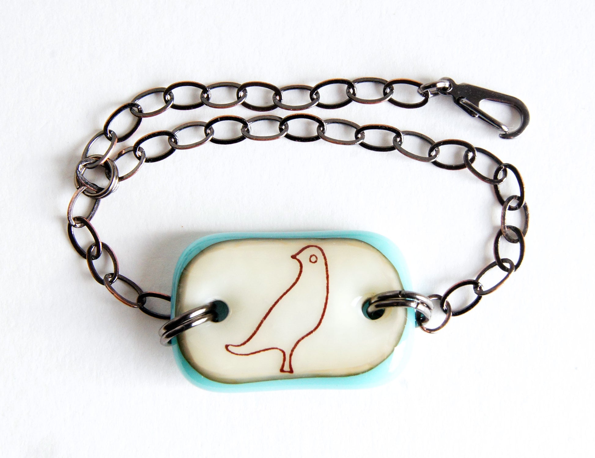 A handmade bird lover bronze chain bracelet with a fused glass dove focal bead.