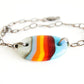 Handmade adjustable bracelet with multicolor striped glass oval bead.