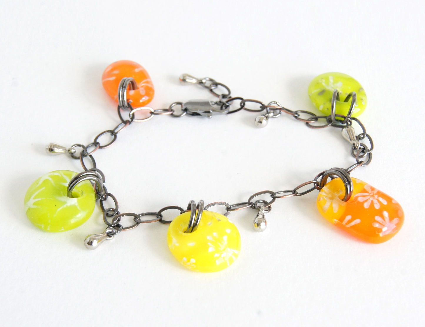 Colorful kiln fired glass drop bracelet with silver stars and flower designs