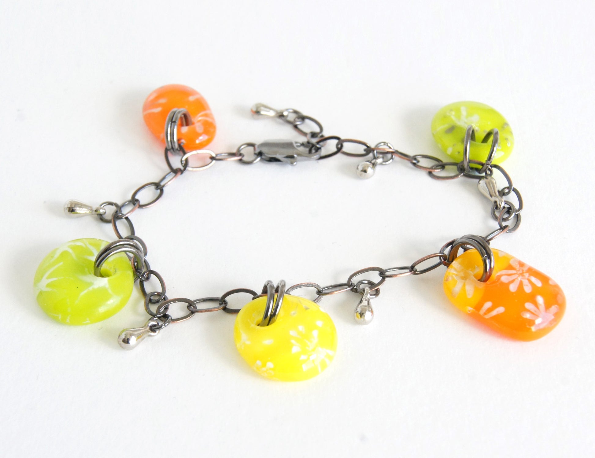Colorful kiln fired glass drop bracelet with silver stars and flower designs