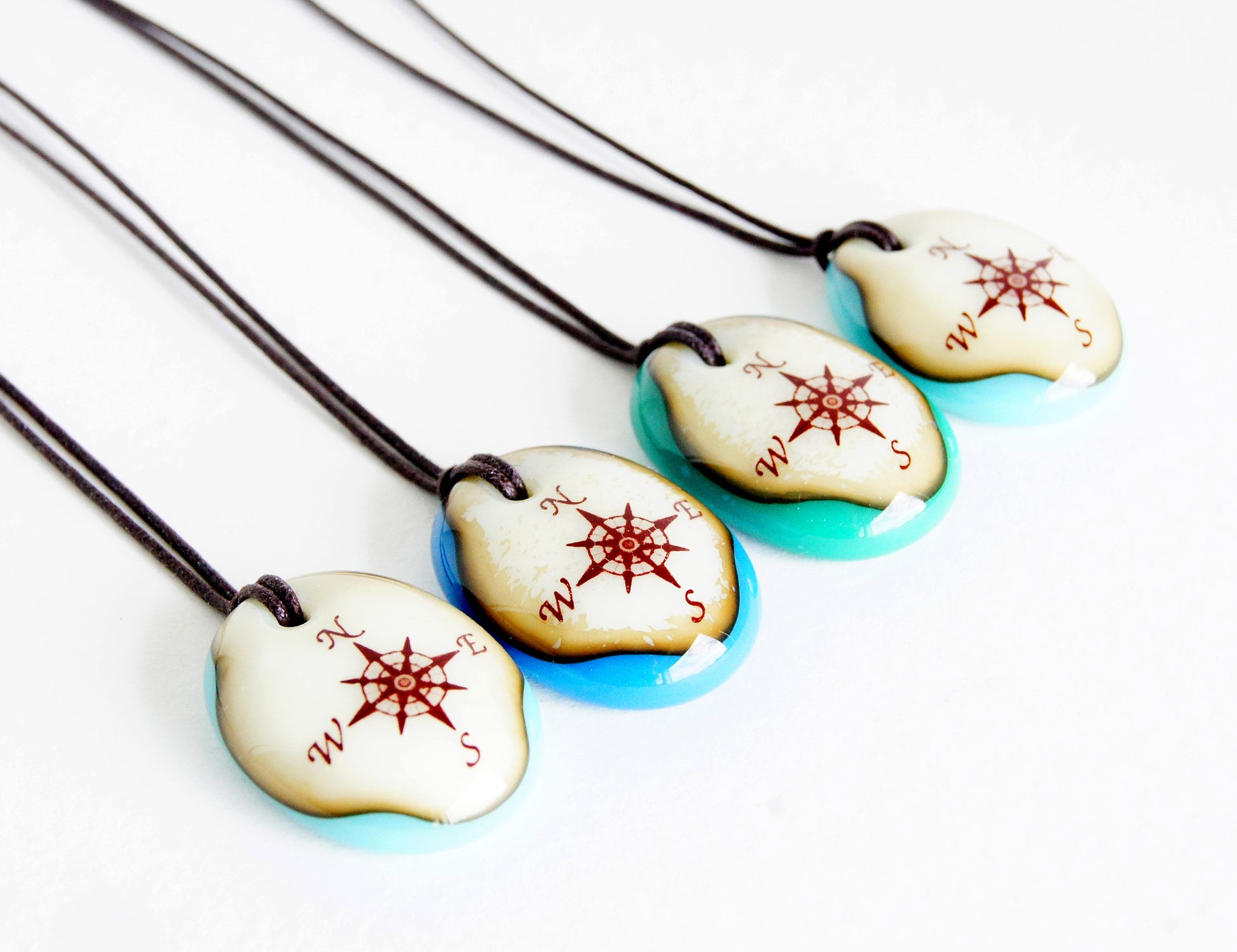 Your choice of handmade compass necklace on cotton cord. 