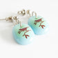 Cute song bird earrings handmade by Leila Cools.