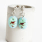 Songbird earrings in pale blue and green glass.