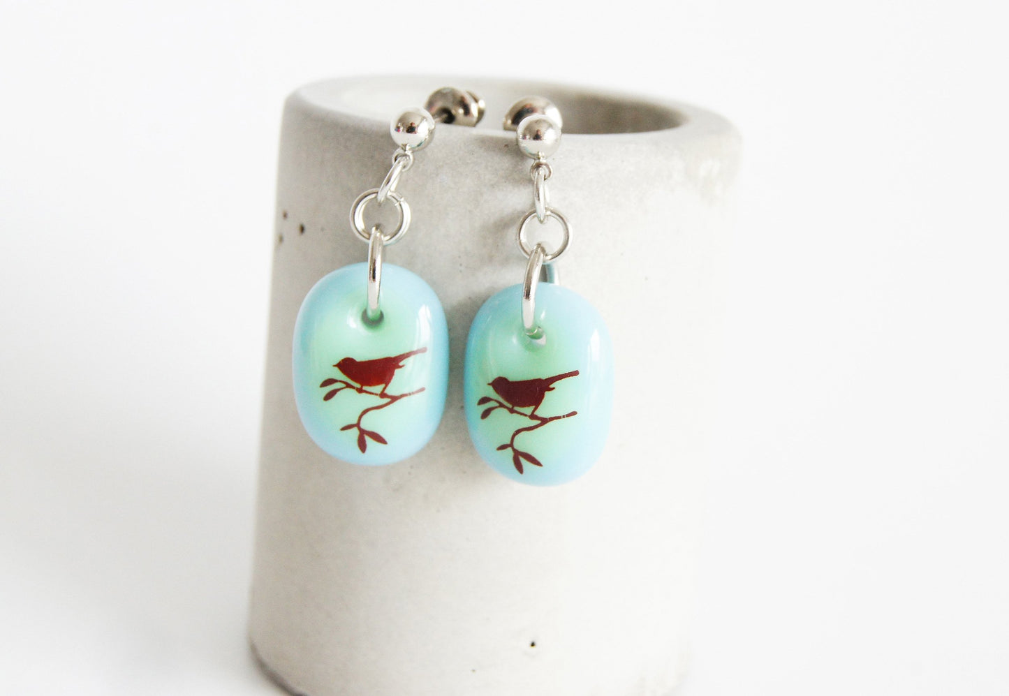 Songbird earrings in pale blue and green glass.