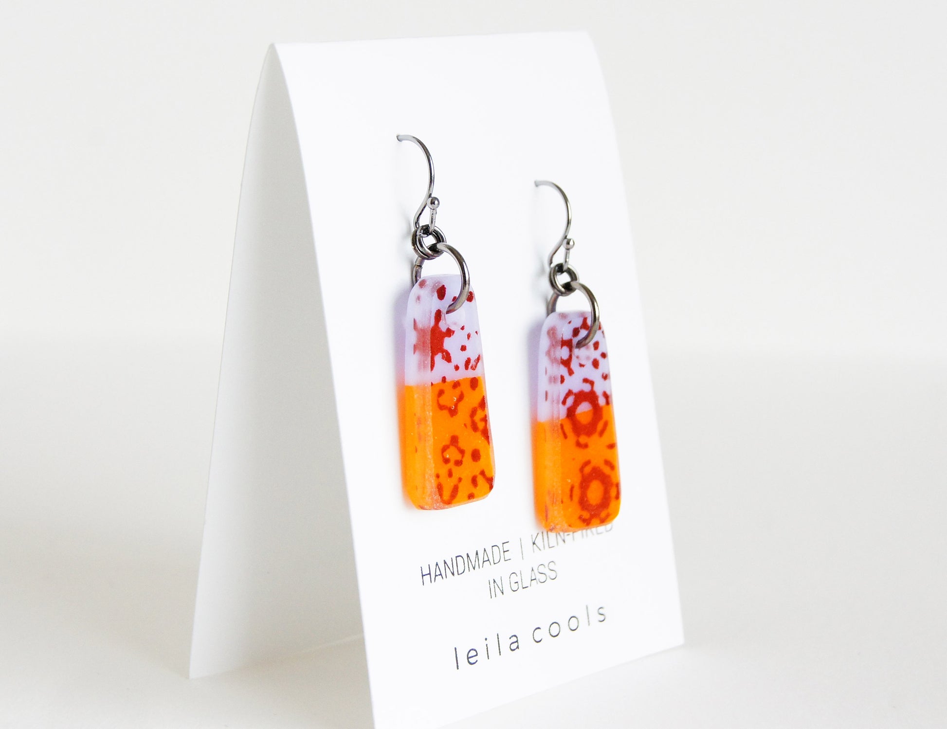 colorful orange and lavender purple glass earrings with sepia pattern design, handmade