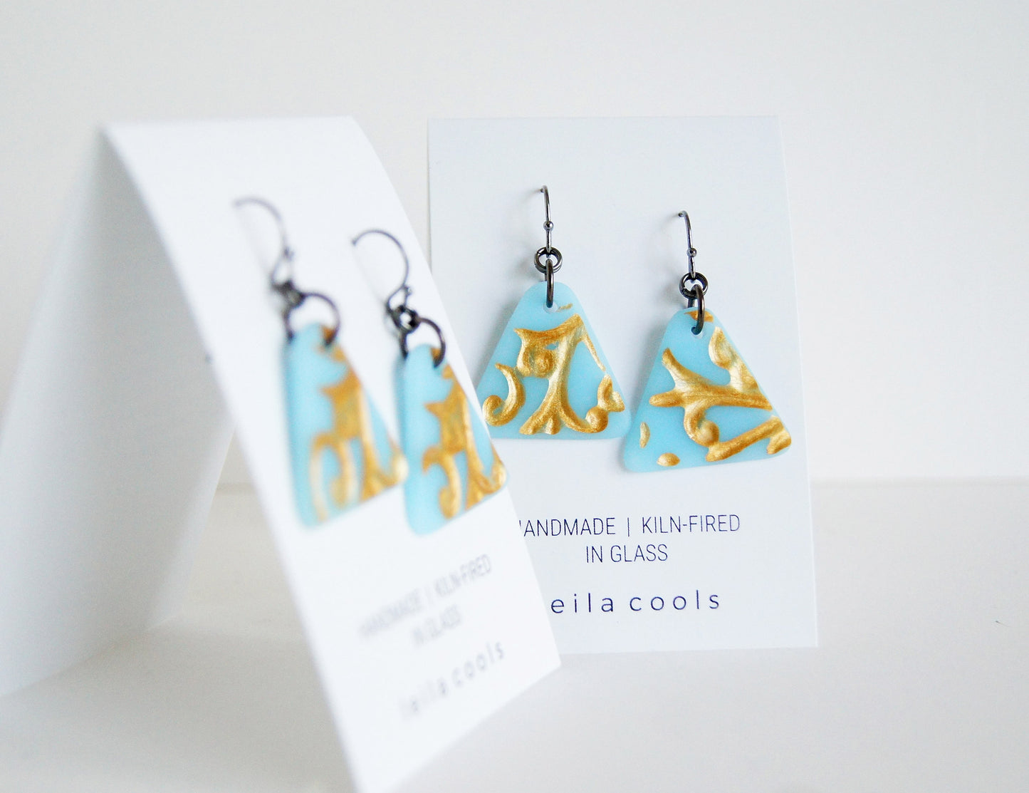 ice blue triangle earrings with gold vine detail