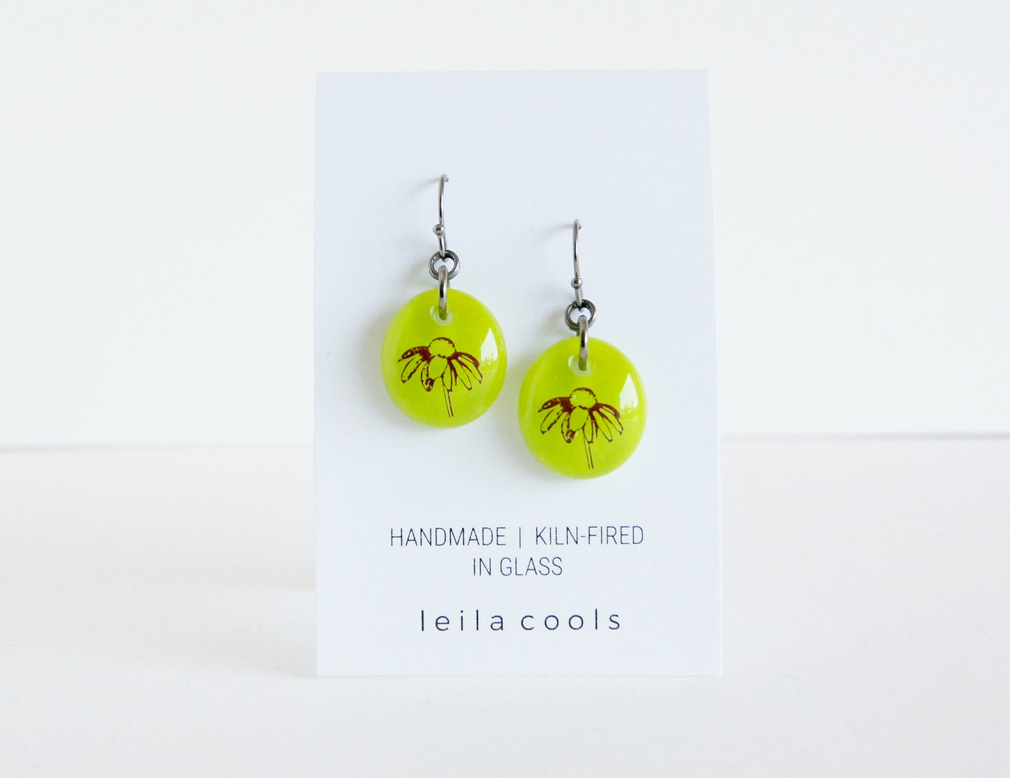daisy flower earrings handmade in light olive, almost chartreuse kiln fired glass by Leila Cools