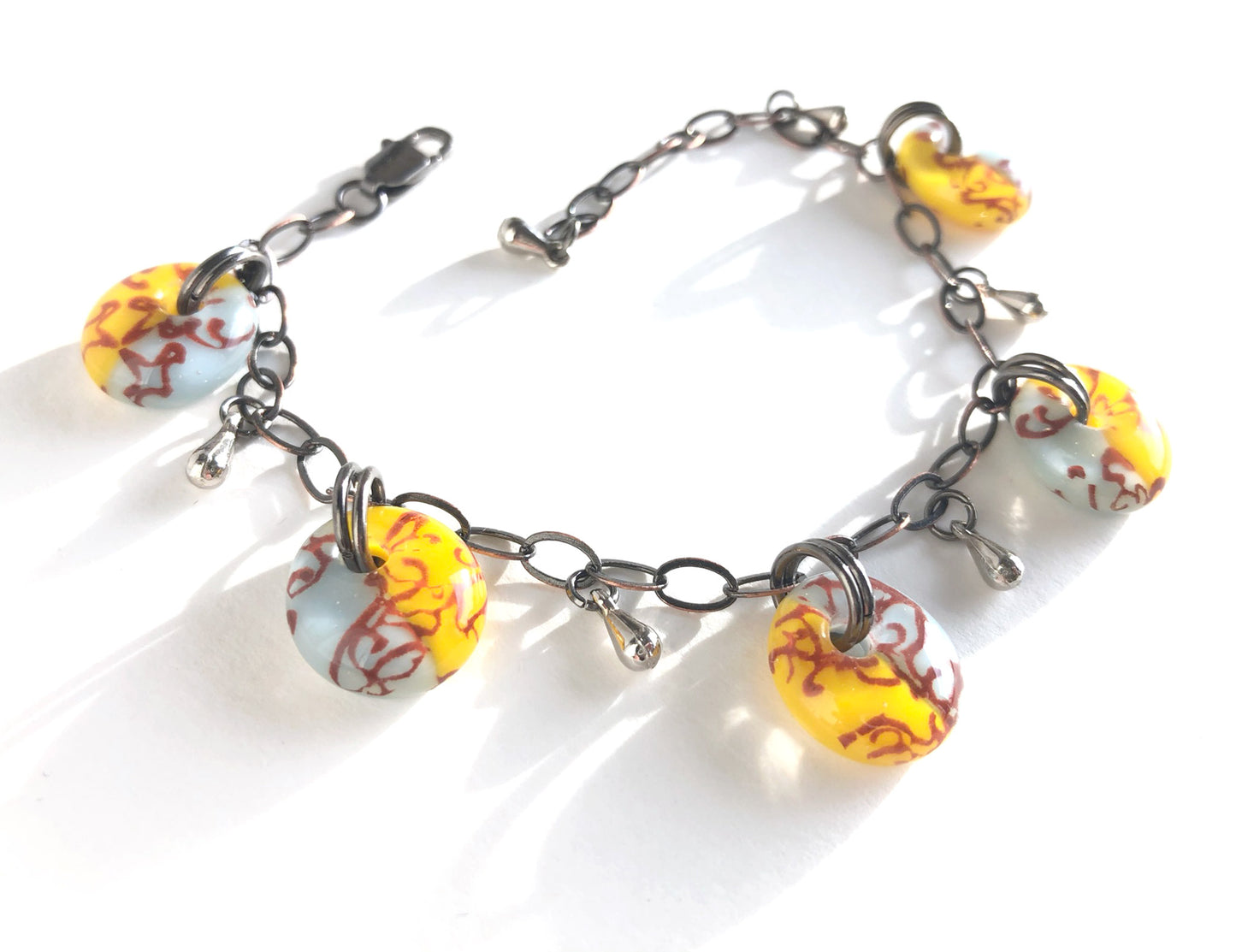 Handmade bracelet with vintage style drops, filigree design and adjustable bronze chain.