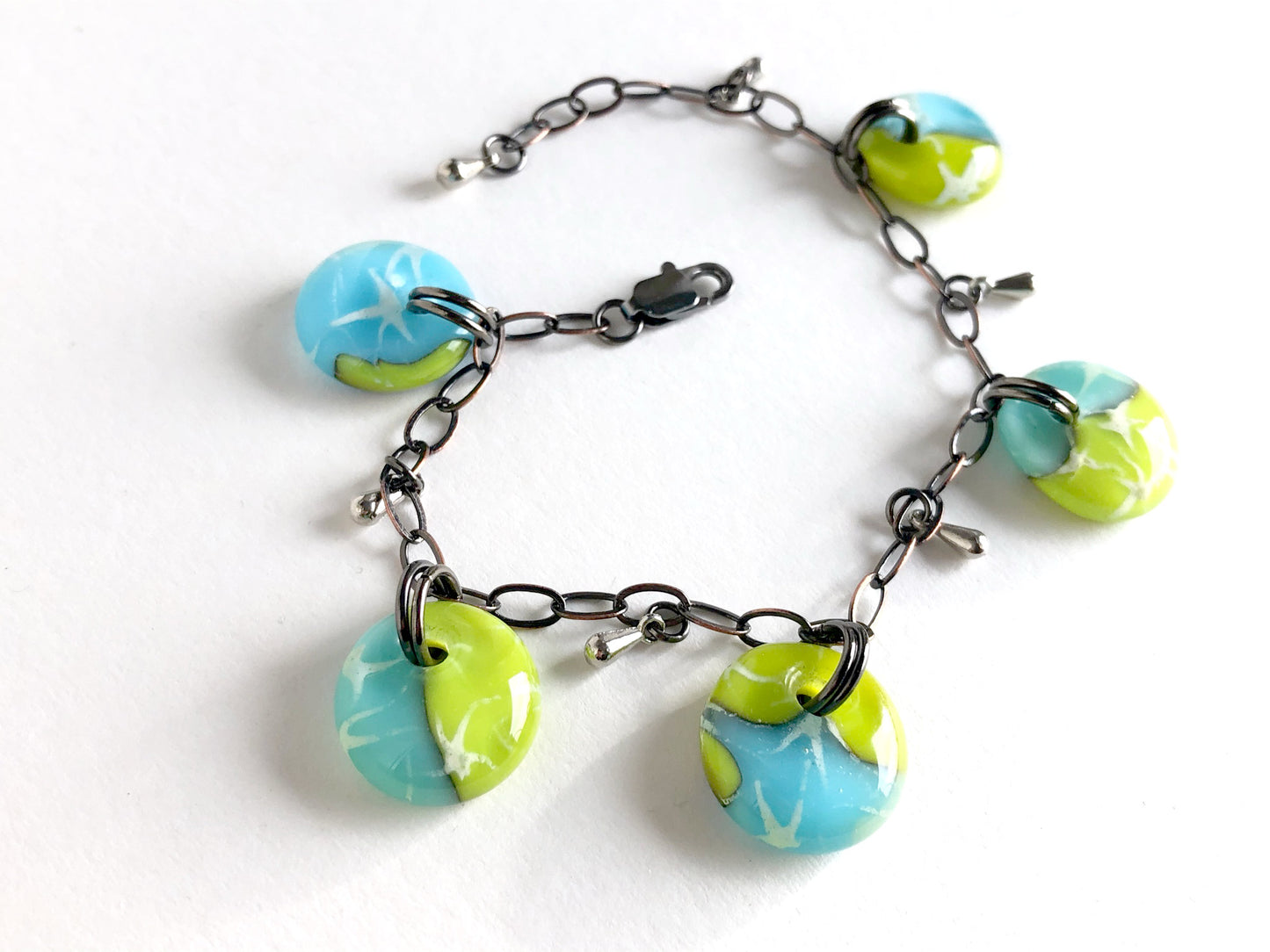 Handmade glass drop bracelet in blues and greens with bronze chain and small steel glass drop beads. 