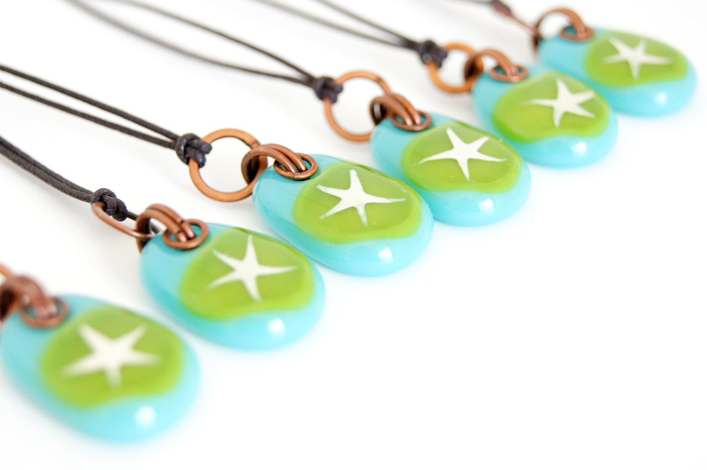 Painted silver star on green glass jewelry. 