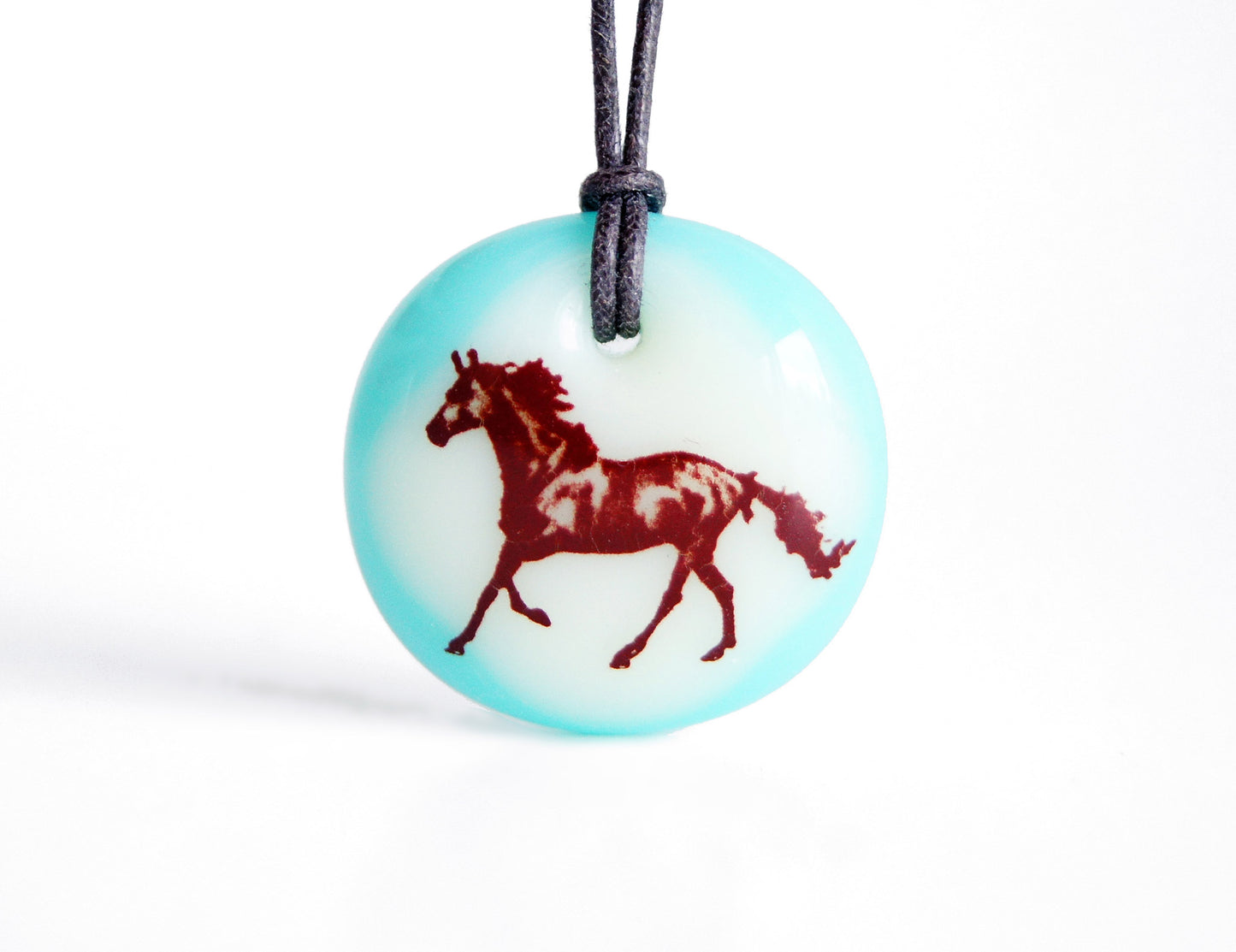Horse necklace in aqua blue glass. 