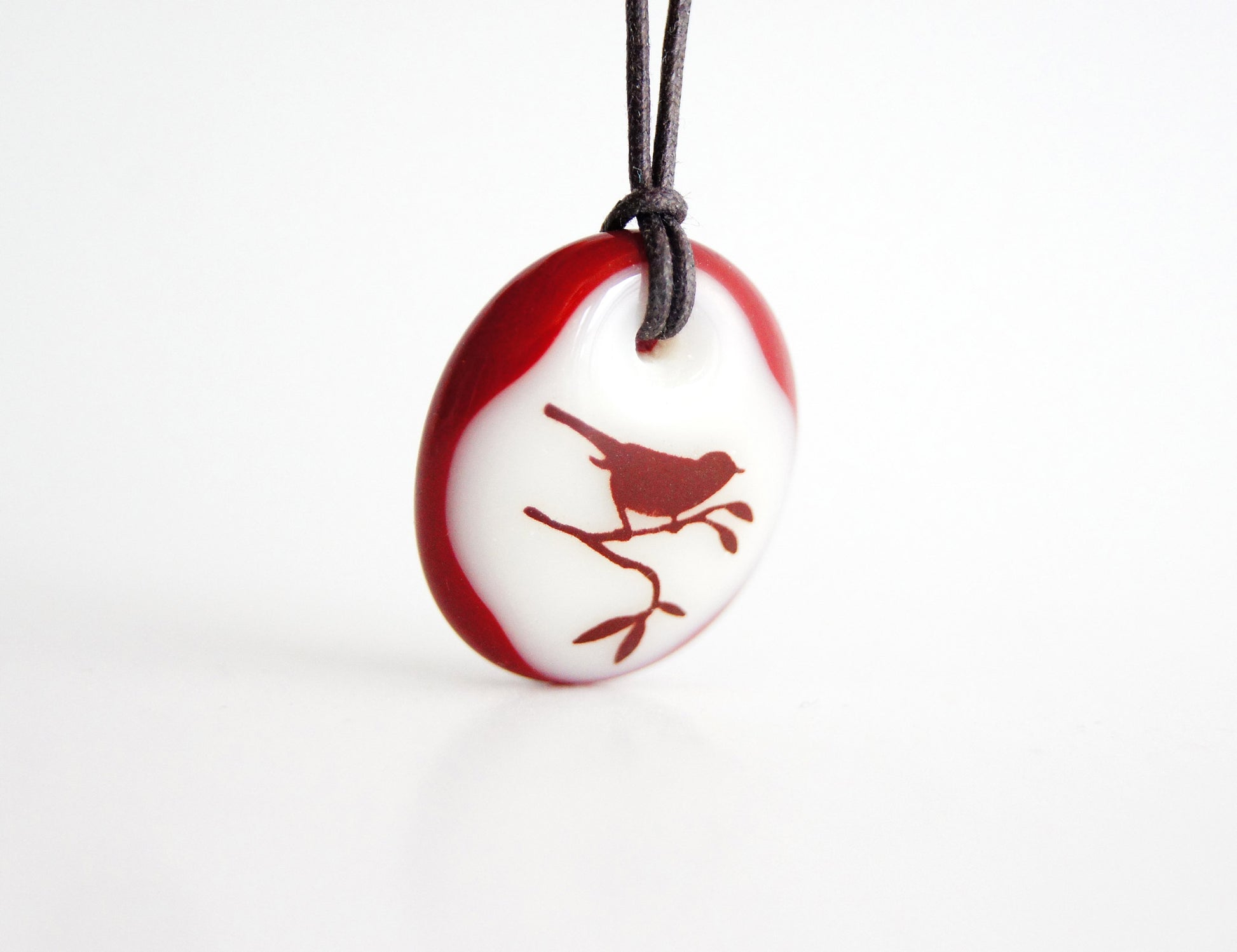 Bird in tree necklace handmade in glass. 